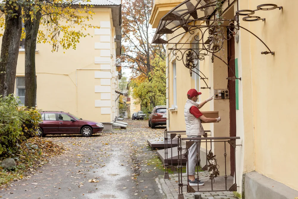 A team member arriving at a residential door