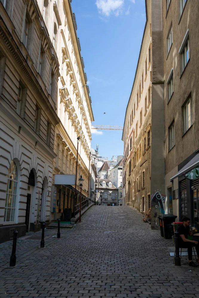 Narrow street between tall Vienna buildings
