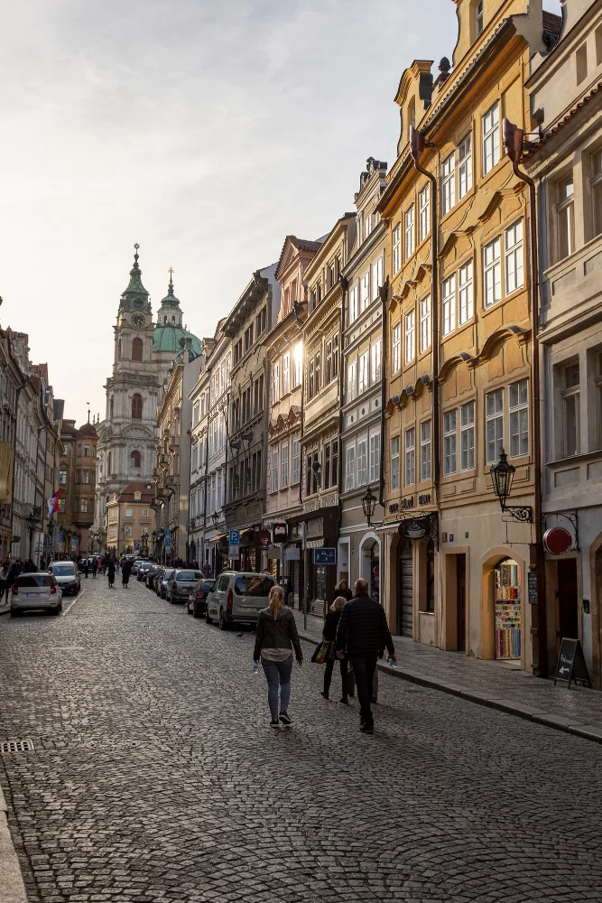 People walking a cobbled street at golden hour